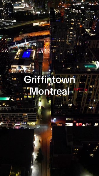 Experience the nighttime allure of Montreal's Griffintown from above. Glide through illuminated streets, capturing the vibrant energy of this dynamic neighborhood. The iconic Farine Five Roses looms in the distance, its lights reflecting off the Lachine Canal, showcasing Montreal's unique charm after dark. #montreal #montrealtiktok #montrealcanadiens #griffintown #montreallife #farinefiveroses #mtl #mtlmoments #urbanexploration #citylights #nightlife #canada
