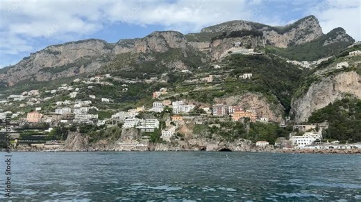 Coastal villages of Praiano and neighboring Amalfi Coast towns seen from a moving ferry, Campania, Italy