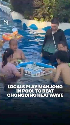 Locals play mahjong in pool to beat Chongqing heatwave