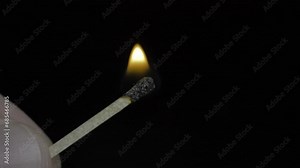 Macro View of lighting a Match. Igniting a match with a box of matches.