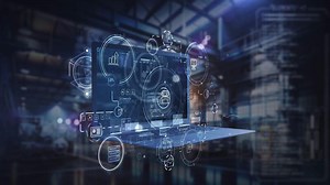 The laptop displays a futuristic control interface against a factory backdrop