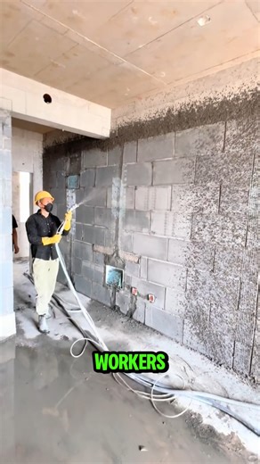 Before plastering, workers spray a thin bonding coat on AAC walls. #BondingCoat #WallPrep #fblifestyle | Lara Amélia