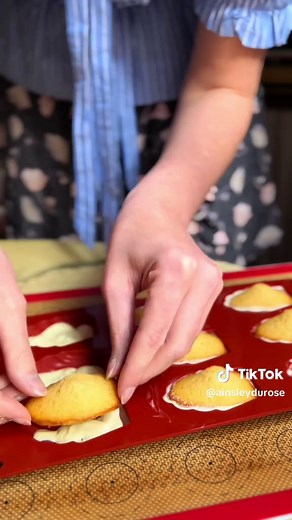 The quintessential French snack, the madeleine! An easy, simple, yet the most delicious treat☺️ it’s a light tender cake, famous for the hump shape on the top! I’ll share the secret on how to get the famous hump shape of a traditional madeleine! Makes about 12-15 85 grams of room temp eggs 65 grams of sugar 15 grams of honey 30 grams of milk 100 grams of plain flour or t55 5 grams of baking powder or levure chimique 100 grams of melted butter Pinch of salt Lemon zest, just a pinch Melt the butte