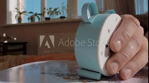 close-up of a male hand, tapping an alarm clock to turn off. morning alarm. 4k video. slow motions. 23.98 fps