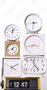 4K footage vertical video front view CU Time-lapse, Many clocks turning to tell the time on a white background.