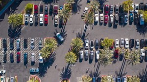 Close up Aerial timelapse of busy parking lot in a commercial center in USA