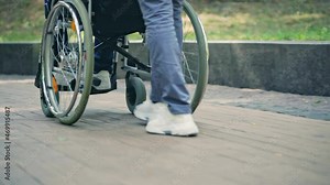 Woman pushing wheelchair of person with disability, family support and care