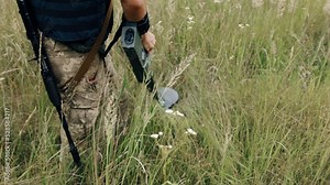 Sapper neutralizing a mine, outdoors, soldier minesweeper using mine detector, training and advanced for sappers, soldier removing mines, sapper examining territory with metal detector