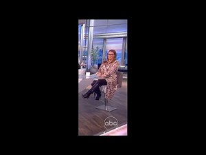 SE Cupp in a satin wrap dress, pantyhose, and boots (10-13-2021)