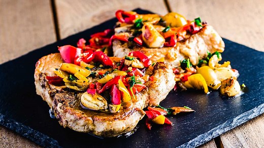Tender braised pork chops in a tangy white wine, garlic, and cherry pepper sauce. Delicious! Full Print Recipe: https://www.sipandfeast.com/pork-chops-vinegar-peppers/ | Sip and Feast