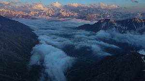 Enticing snowy mountains rising touch cloud filled skies drone view Journey through enticing snowy mountains experience Earth's rugged grace. Nature's masterpiece enticing snowy mountains.