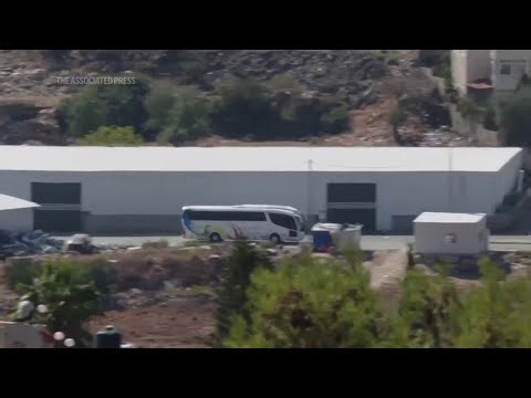 Buses thought to be carrying released Palestinian prisoners leave West Bank's Ofer prison