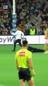 Last night’s pitch invader at Adelaide Oval could face a three-year ban from the stadium. The crowd filmed as he jumped a fence, then charged onto the arena, running between Crows and Port Adelaide players. Security chased the man from all angles, finally tackling him to the ground. Full story LIVE, 6pm on #9News | 9 News Adelaide