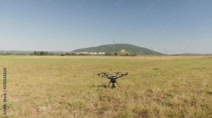 Drone/UAV start up, take off - wide angle of the engine starting. Propellers rotate fast. 4K Real Time