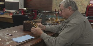 Man passes time by fixing all kinds of clocks