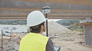 Construction supervisor inspecting a large road construction site using GPS equipment Stock Video
