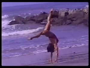 Muscular female bodybuilder does cartwheels & handstands