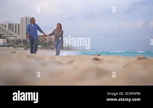 Mature lovers sitting at beach and enjoying the view