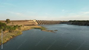 Wide view of Bloemhof dam wall, low above Vaal River water level, slowly approach