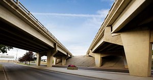 Oversized Load Hits Overpass So Hard an Excavator Was Knocked off the Trailer