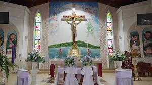 Pull out shot of wedding decors of the altar inside a catholic church