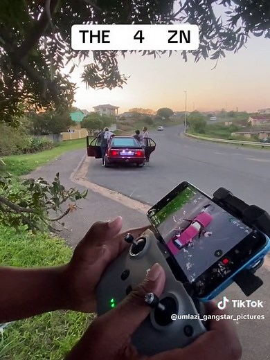 Group of Friends Observing a Red Car in Suburbia