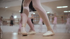Ballet training - group of little girls stands on the pointe shoes