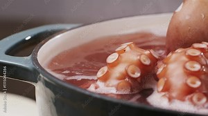 Octopus cooking, chef Boiling fresh octopus on restaurant kitchen, healthy food, seafood cafe in spain, traditional asian japanese spanish and mediterranean dish.
