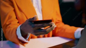 African american girl doing online shopping session at home, typing debit card numbers to finish website order. Young woman purchasing clothes with easy pay e banking, home delivery. Camera A.