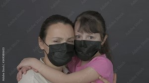 Sad family with virus. Frightened mother and daughter wearing protective masks.