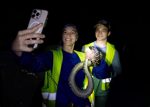 The lighter side of annual Florida Python Challenge: hunter takes selfie with giant snake