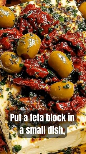 Warm feta, olives, and sun-dried tomatoes in garlicky herby oil. Scoop with toast. #easyappetizer #bakedfeta #partyfood | Kristina Recipes
