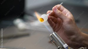 Glass eye prosthetic production (Ocular prosthesis). Burning Glass on a burner. 4K Video