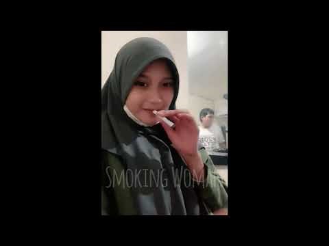 This woman in hijab casually smokes at work