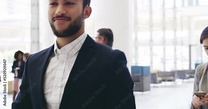 Rock on hand sign, gesture and symbol of confident, excited and fun businessman walking in office. Portrait of fun, successful or expressive executive walking through a modern office building