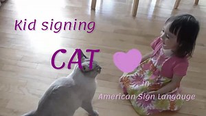 Kid signing CAT in ASL
