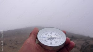 The compass is in the hands of a hiker. Find a way in the Misty Mountains