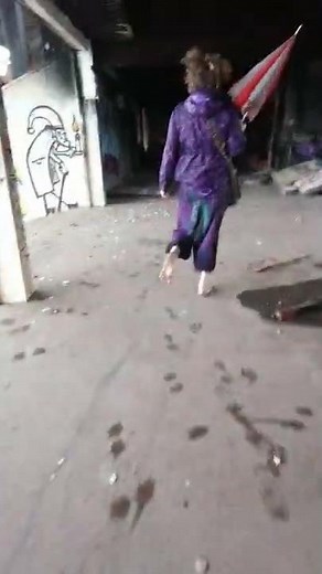 Barefoot hippie girl in an abandoned stadium