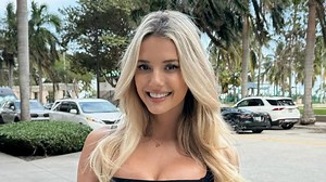 'World's sexiest racing driver' goes braless in revealing cut-out top