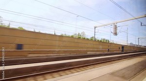 View from the window moving train along railway platform. Train railroad. Country trip on train
