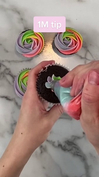 Piping rainbow neon pastel cupcake roses in every color