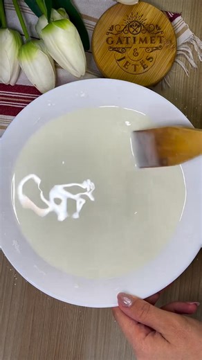 Revani me niseshte 📍Albania 🇦🇱 Revani me niseshte is a traditional Albanian dessert similar to revani or basbousa but made with cornstarch instead of semolina, which gives it a smooth, delicate texture. After baking, it’s soaked in a sweet syrup (shërbet) that makes it moist and fragrant. This simple yet flavorful dessert is often called hasude e pjekur in some regions and is a beloved treat for family gatherings and holidays. Video: @kuzhinierja_e_vjeter | TasteAtlas