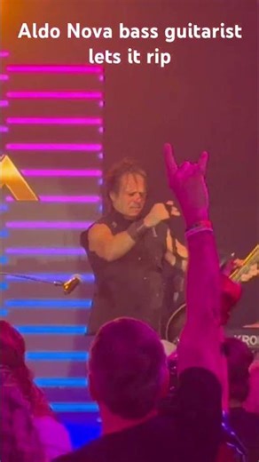 Aldo Nova bass guitarist Darius Seixas swings his bass from his neck. Full clip on channel
