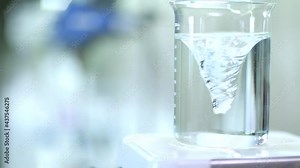 Twisting water in beaker by Spinning water vortex machine