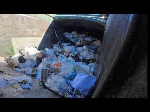 Waste Management commercial garbage truck smashing garbage