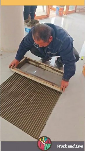 The process of applying tile adhesive over floor tiles