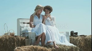 Lesbian couple. Friends relaxing on the farm. Young couple having fun on a farm. Girls enjoying summer, spring.