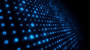 Blue tech background with a glowing grid of digital data lights streaming past the camera. Big data network server concept. This sleek modern technology background is full HD and a loop.