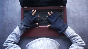 Download hacker hand stealing data from laptop top down. for free