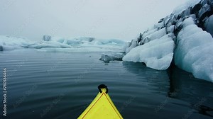 Winter Kayaking in Jökulsárlón the Glacial Lake in Iceland with Iceberg in a Yellow Kayak. Jokulsarlon Icebergs